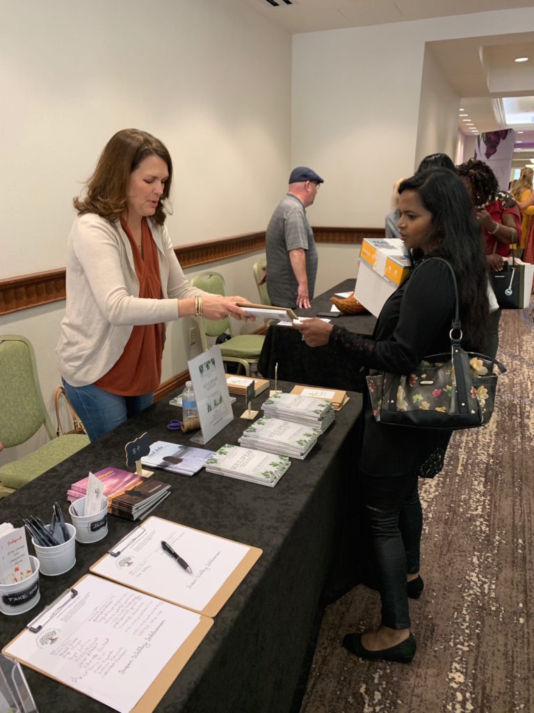 This is a picture of me selling books at my book table, at a women's event.